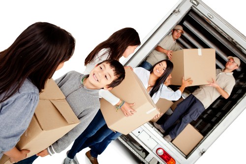 Careful loading of household items into a van near Parsons Green
