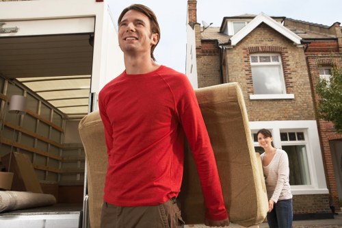 Helpers loading boxes and furniture for a Parsons Green relocation