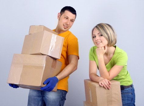 Local moving team assisting with household items and storage boxes